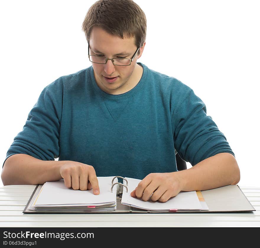 One man sitting at a desk reading in paperwork. One man sitting at a desk reading in paperwork