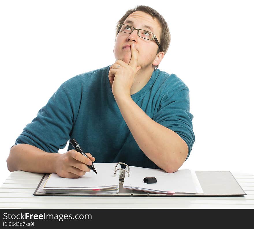 One man sitting at a desk thinking about things doing paperwork. One man sitting at a desk thinking about things doing paperwork