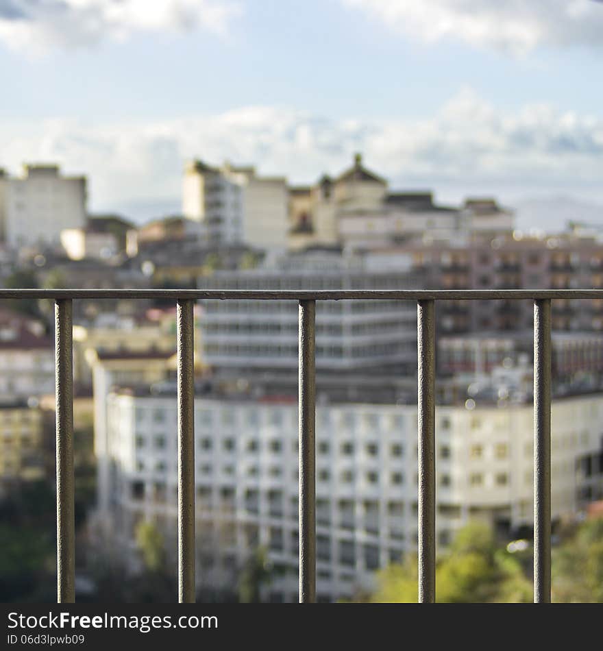 CITY IN THE BACKGROUND, VIEW THROUGH A RAILING IN THE SPOTLIGHT