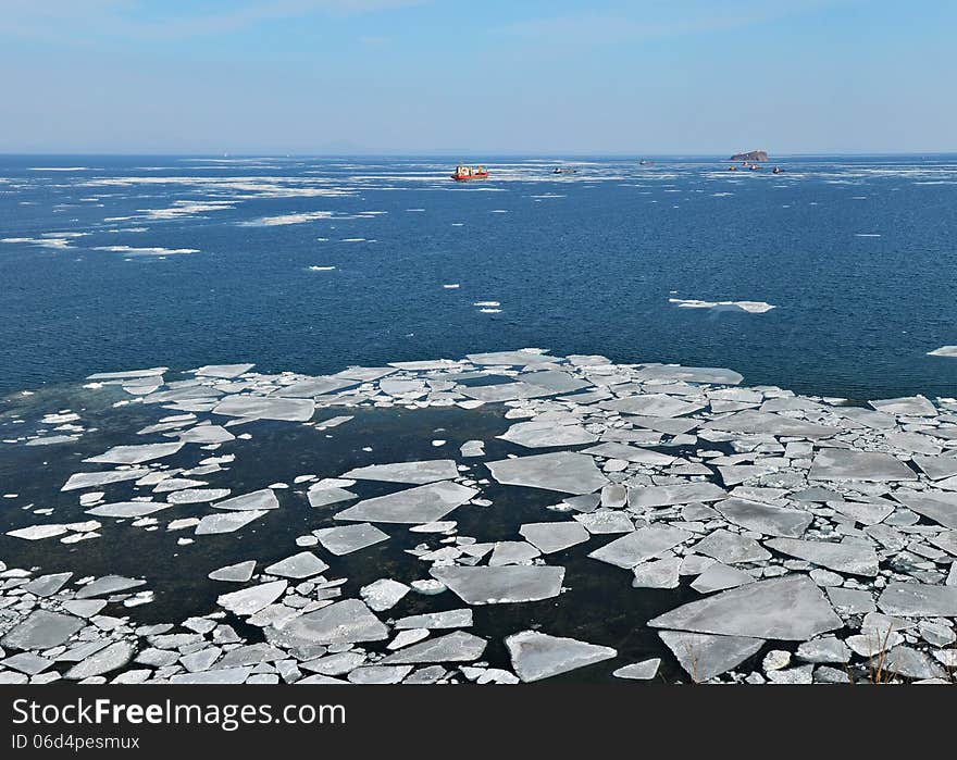 Floating of ice in Sea of Japan, ships in winter ocean, floating of ice