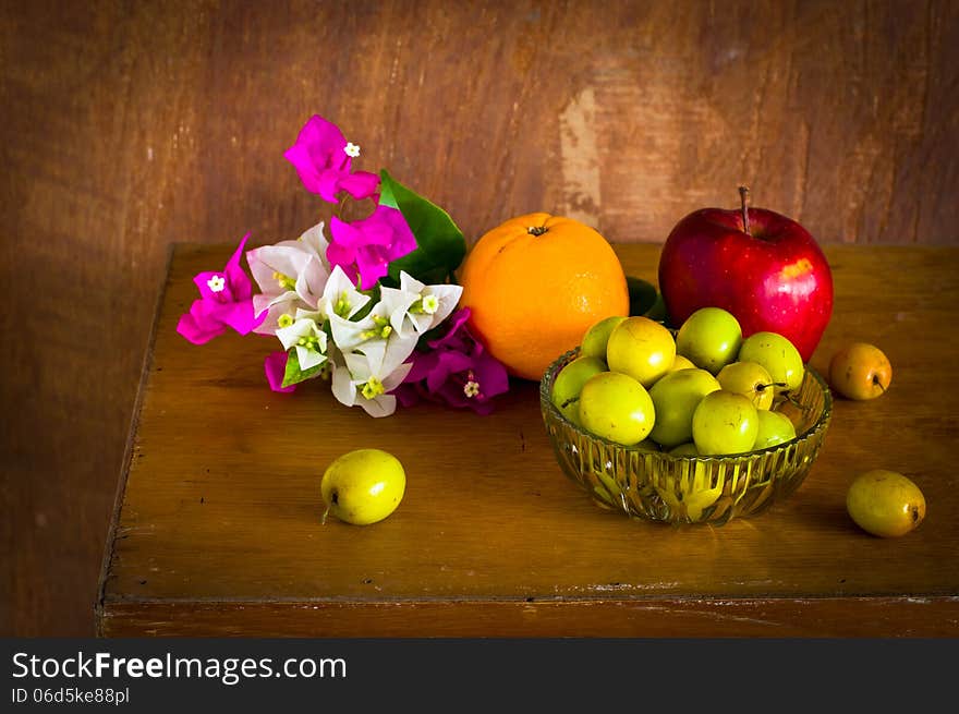 Fresh Bougainvillea flower and Many kind of fruit on old wood table ,still life. Fresh Bougainvillea flower and Many kind of fruit on old wood table ,still life