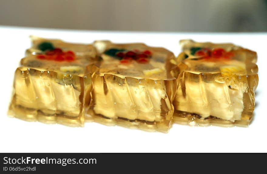 Bright tasty food fish in aspic on a light background. Bright tasty food fish in aspic on a light background