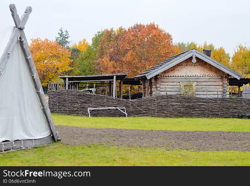 Ancient wooden Slavic house in outdoor museum on beautiful autumn day