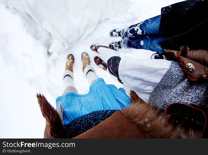 People s legs on snow white winter background fisheye