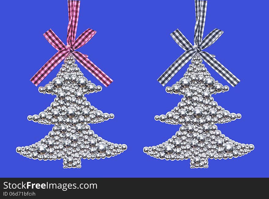 Two silver Christmas tree - decoration isolated on blue background. Two silver Christmas tree - decoration isolated on blue background