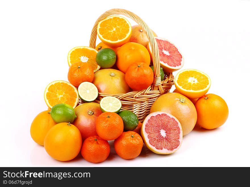 Wicker basket with various types of citrus fruits on white background. Wicker basket with various types of citrus fruits on white background