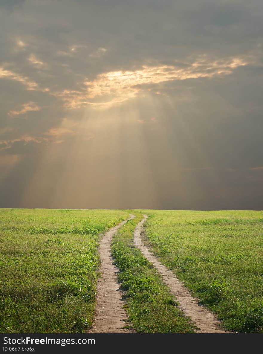 Green grass, road and sky. Green grass, road and sky