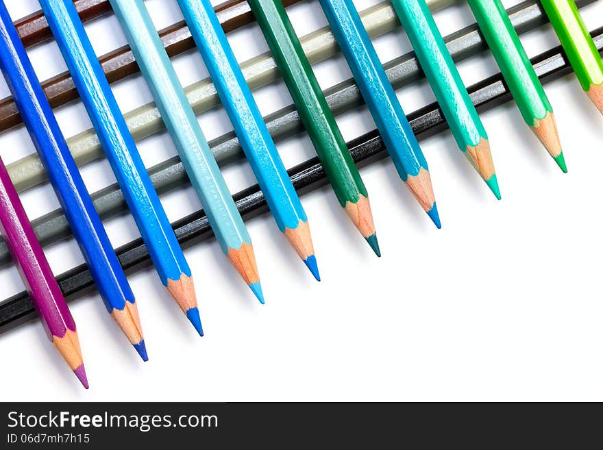 A group of colourful colour pencils lined up side by side