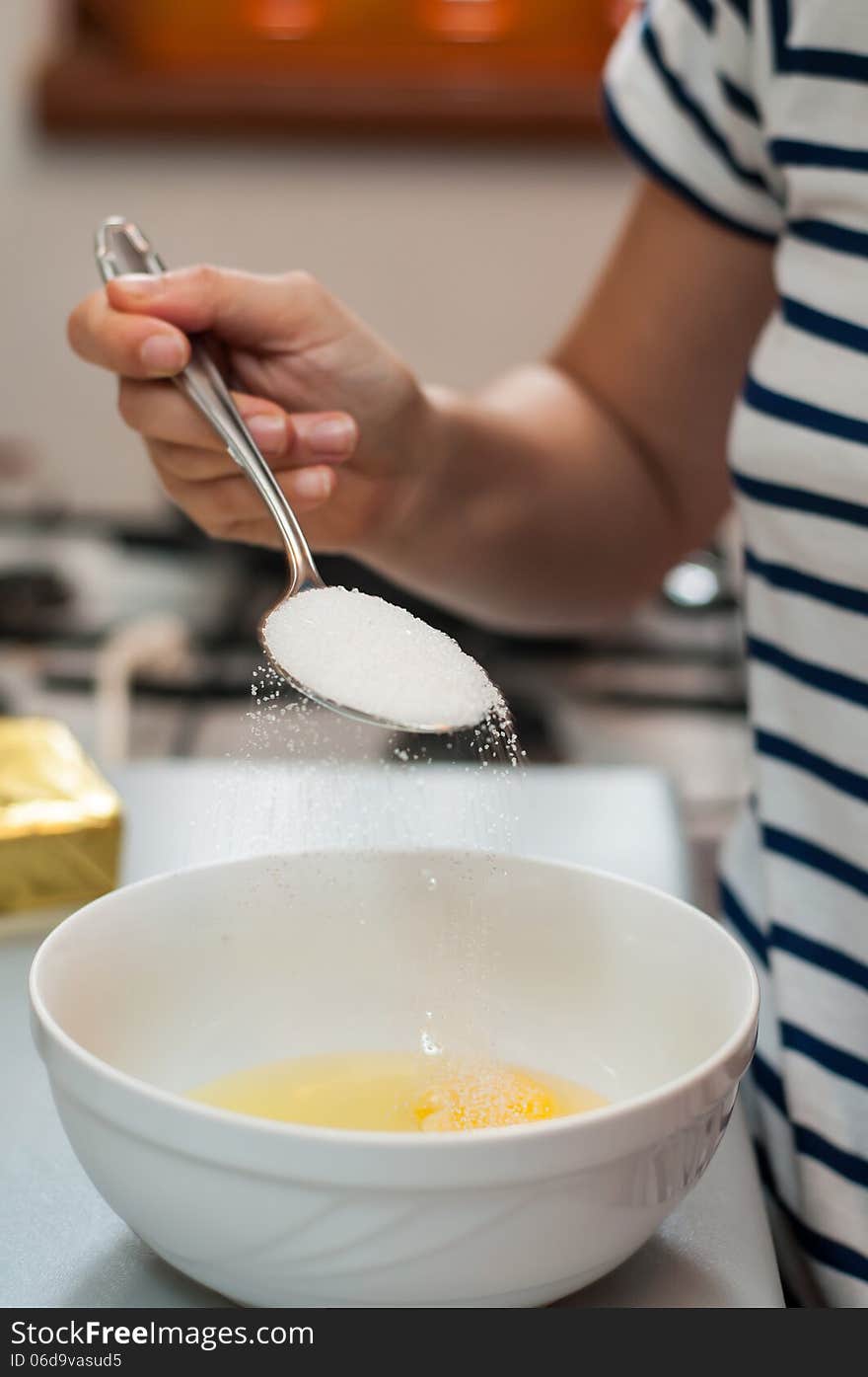 Woman mixing sugar and eggs for dessert