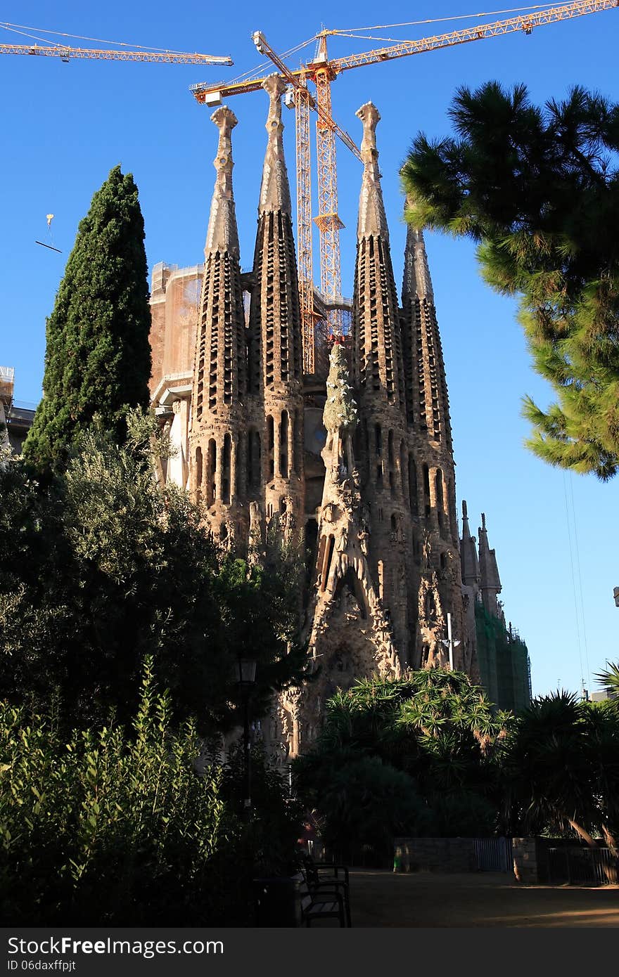 Facade of the Sagrada Familia near few construction cranes. Barcelona, Spain. Facade of the Sagrada Familia near few construction cranes. Barcelona, Spain