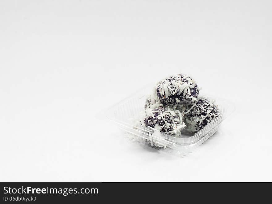 Thai dessert sweet boiled ball , roll over the grated coconut on White background