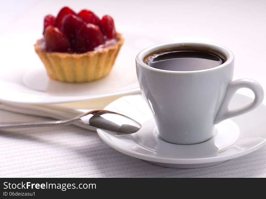 Whie Cup of Black Coffee with Strawberry Dessert in a Waffle Basket