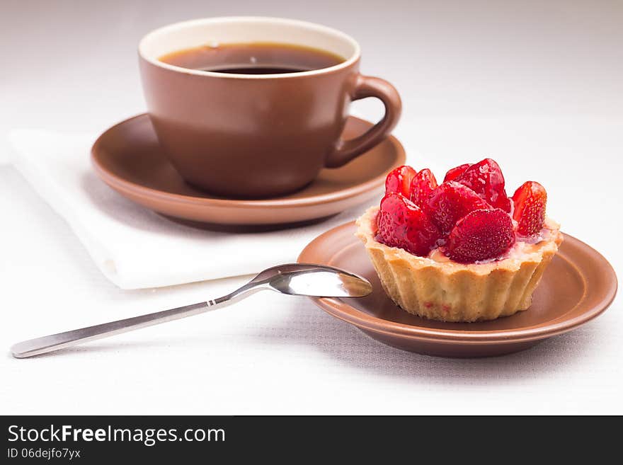 Strawberry dessert in Waffle Basket with Cup of Hot Tea. Strawberry dessert in Waffle Basket with Cup of Hot Tea