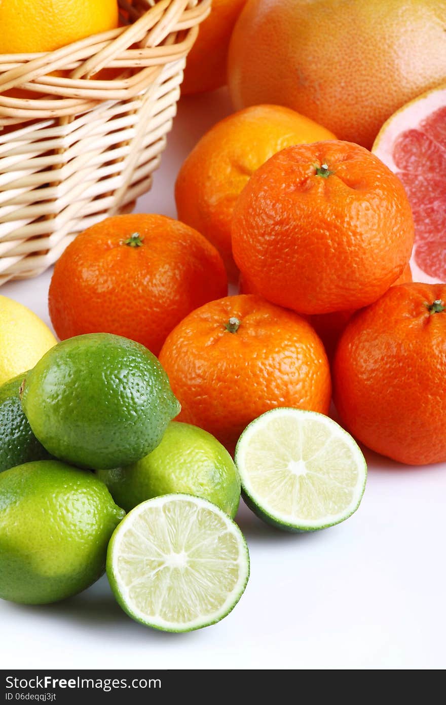 Wicker basket with various types of citrus fruits on white background. Wicker basket with various types of citrus fruits on white background