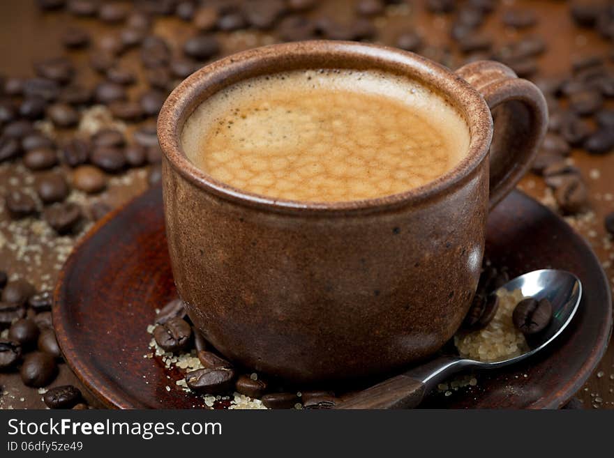 Cup of black coffee with foam, selective focus, close-up