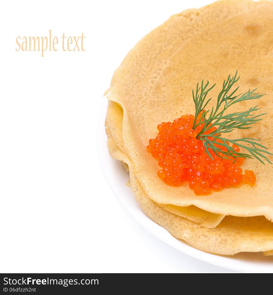 Stack of crepes with red caviar on a plate, close-up, isolated