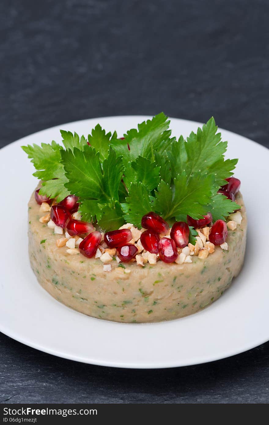 White bean pate with nuts and pomegranate seeds, vertical