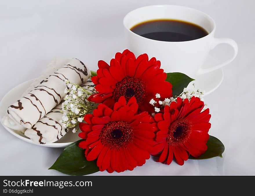 Cup of coffee, cookies and flowers