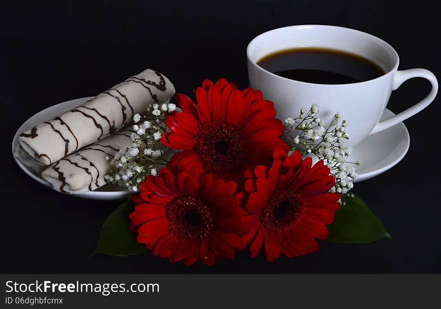 Cup of coffee, cookies and red flowers on a black background. Cup of coffee, cookies and red flowers on a black background