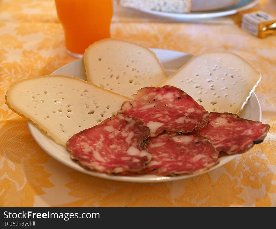 Typical Italian breakfast with cheese and traditional salami