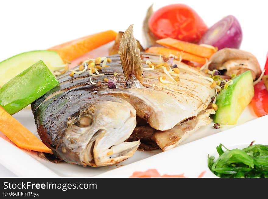 Fried wish with grilled vegetables and chukka seaweed, macro closeup