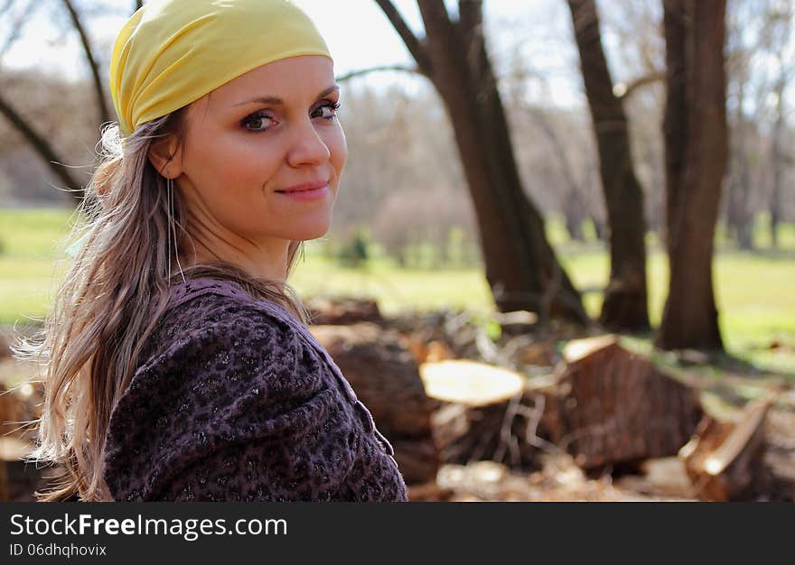 Beautiful girl with a scarf on her head on a background of nature