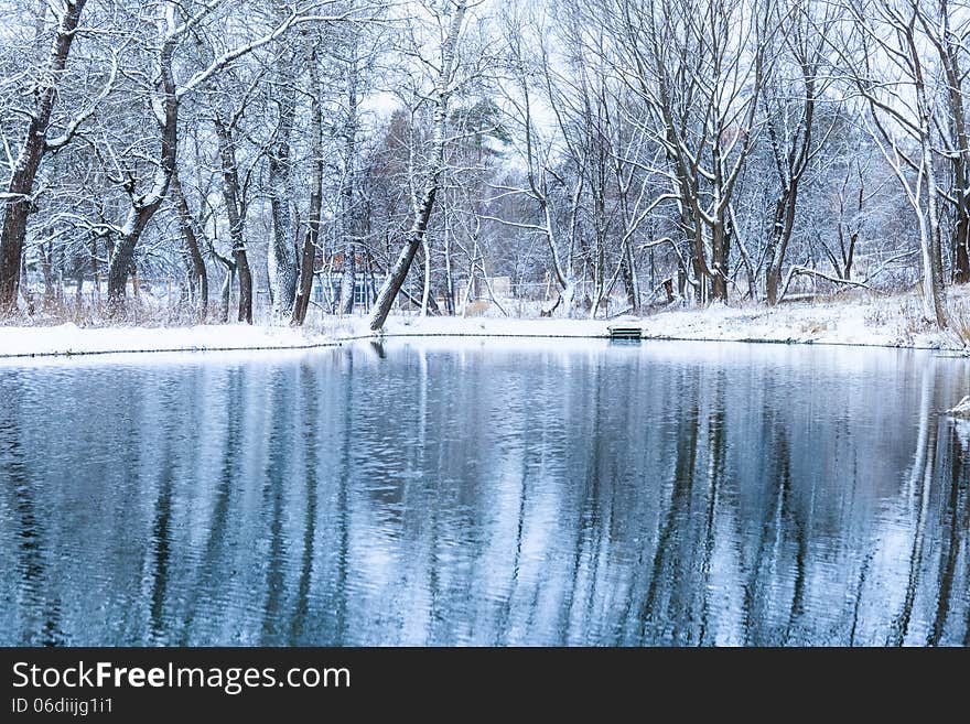 Not frozen pond in winter