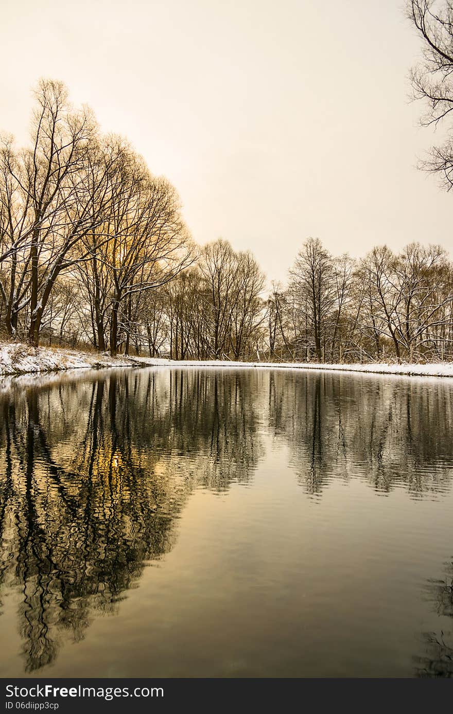 Not frozen pond in winter