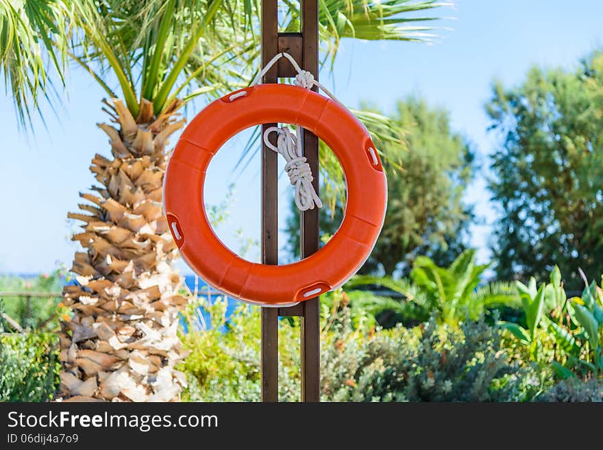 life buoy with rope hanging around the pool