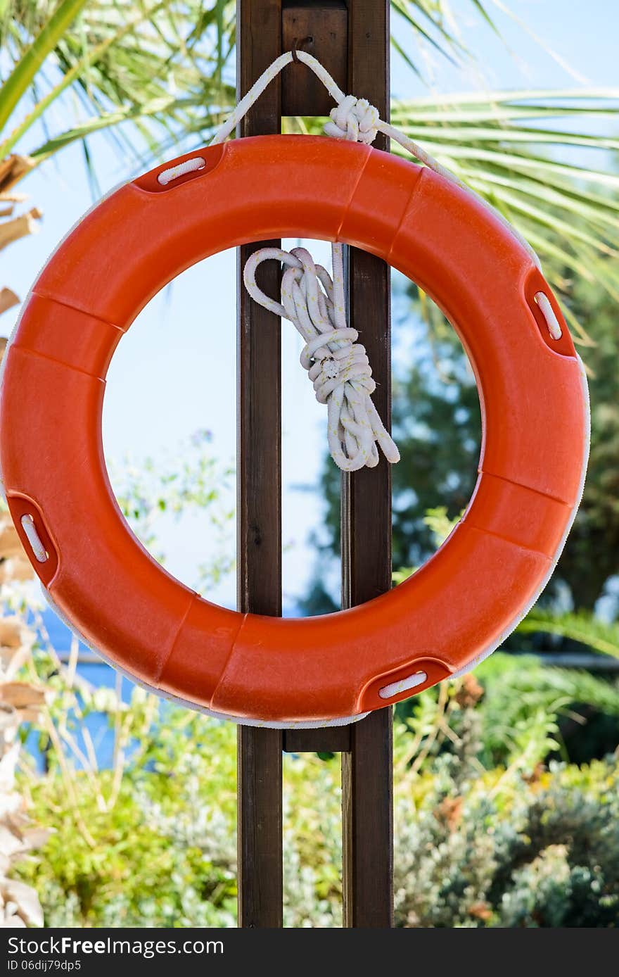 Life Buoy With Rope Hanging Around The Pool