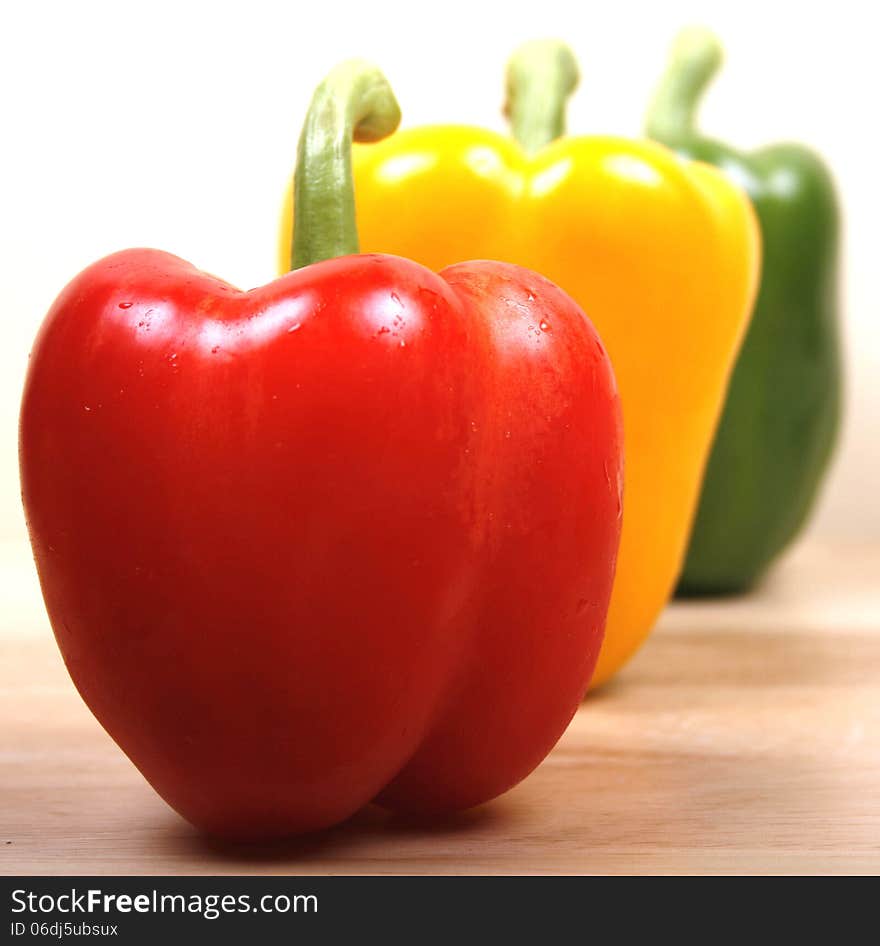 Three sweet peppers in a line