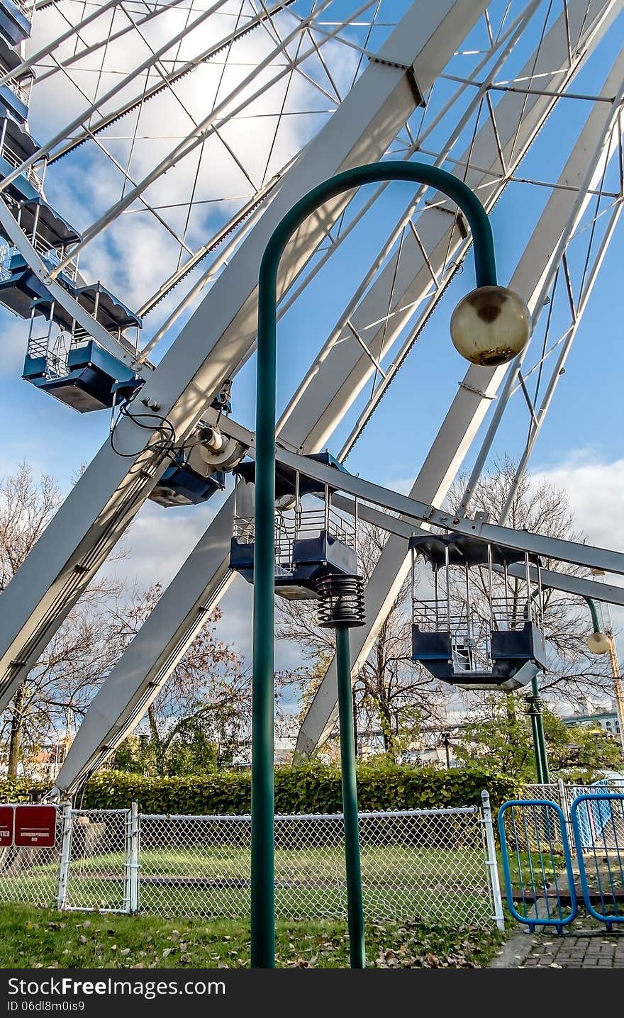 Low angle view of ferris wheel with blue sky background. Low angle view of ferris wheel with blue sky background.