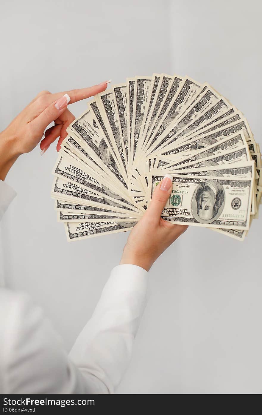 A Young Woman With Dollars In Her Hands, Isolated On White