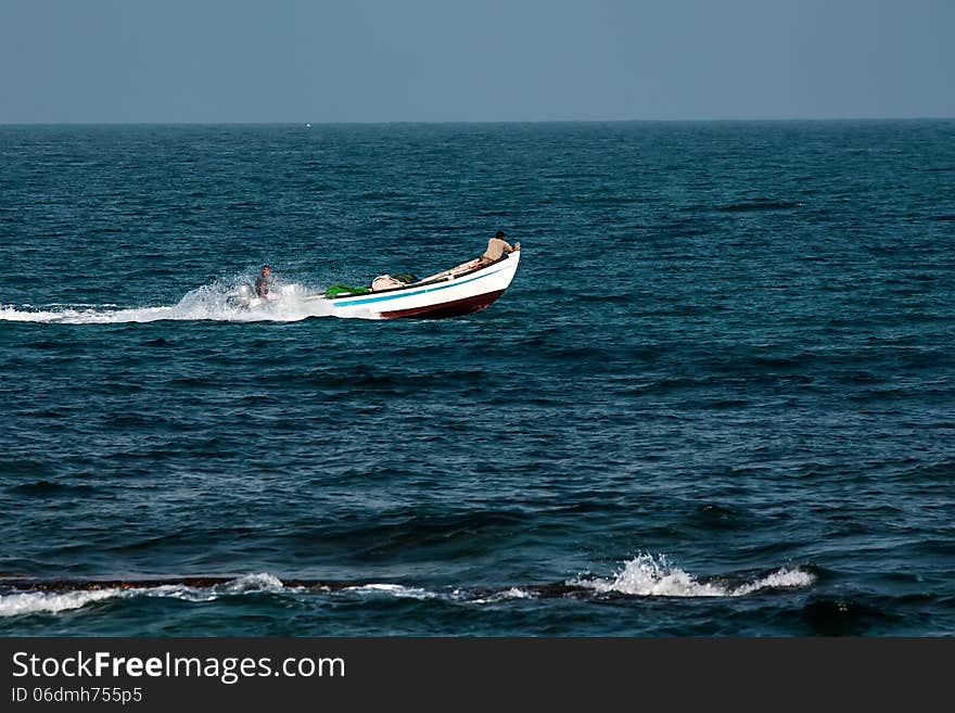 Fishermen on a motorboat background