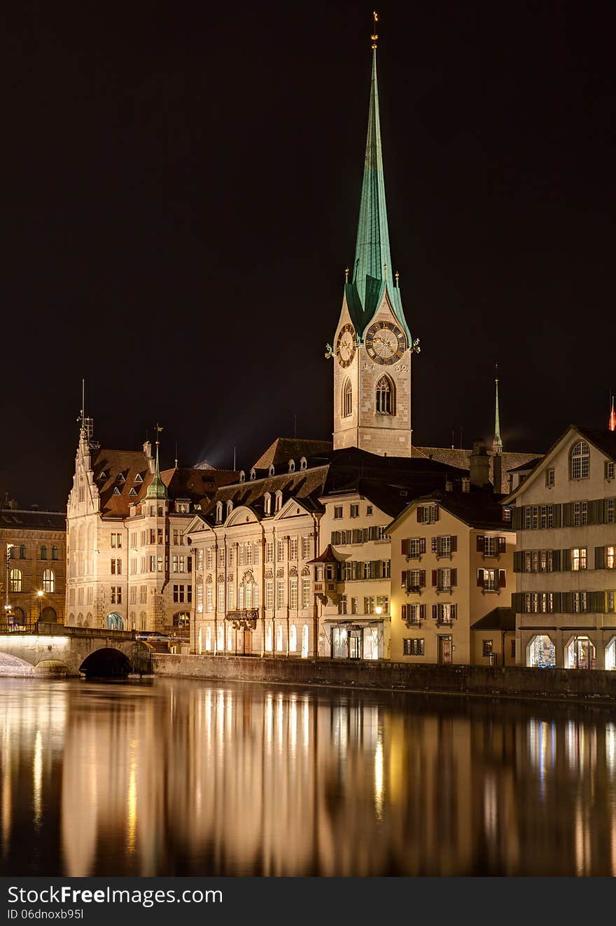 Zurich, Switzerland. The Lady Minster cathedral and the Limmat river in the evening. Zurich, Switzerland. The Lady Minster cathedral and the Limmat river in the evening.