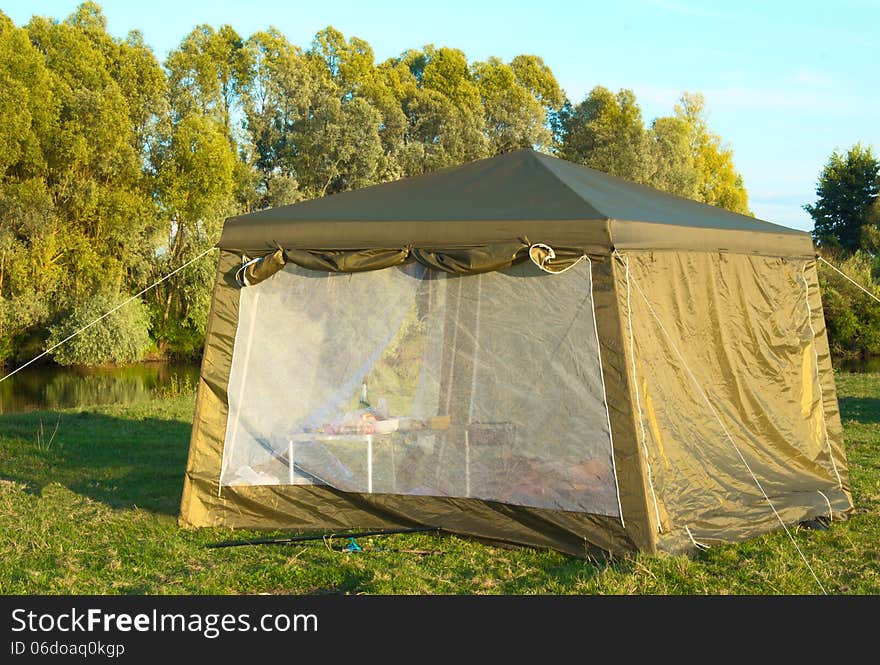 A big tourist tent on the Bank of the river.