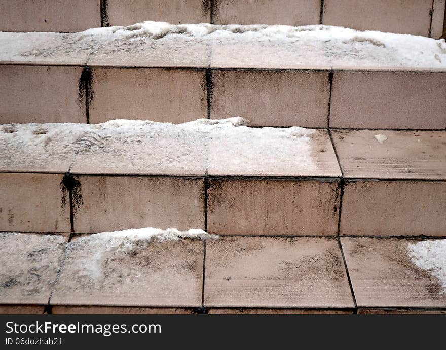 Fragment of the ladder which has been laid out by ceramic tiles. snow and ice lie on wet steps. therefore they very slippery. Fragment of the ladder which has been laid out by ceramic tiles. snow and ice lie on wet steps. therefore they very slippery.