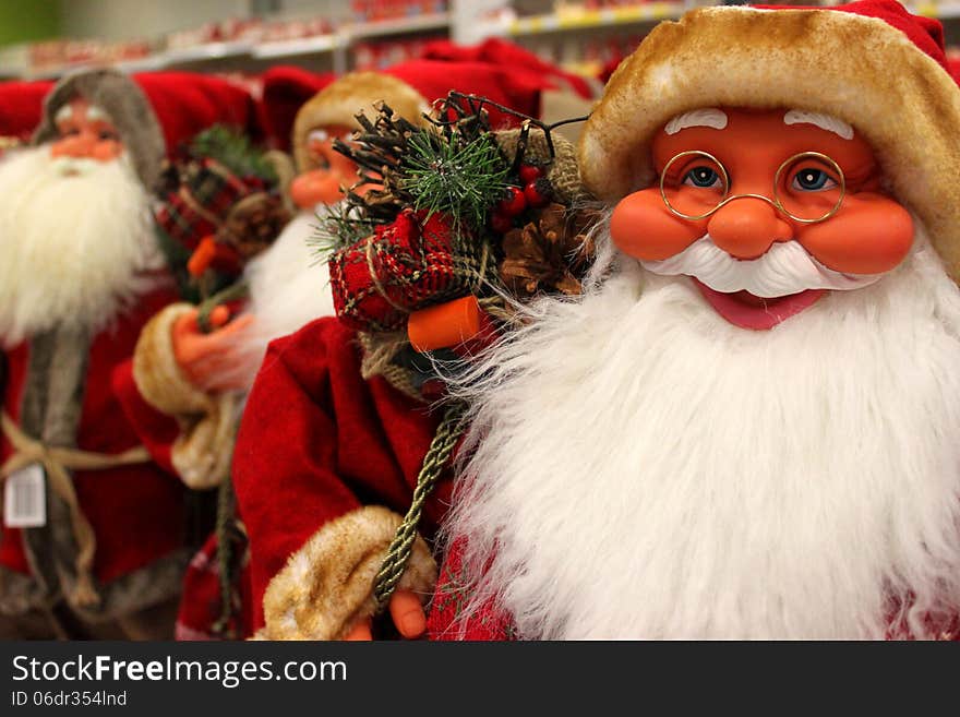 Santa Clauses smiling from toy store.