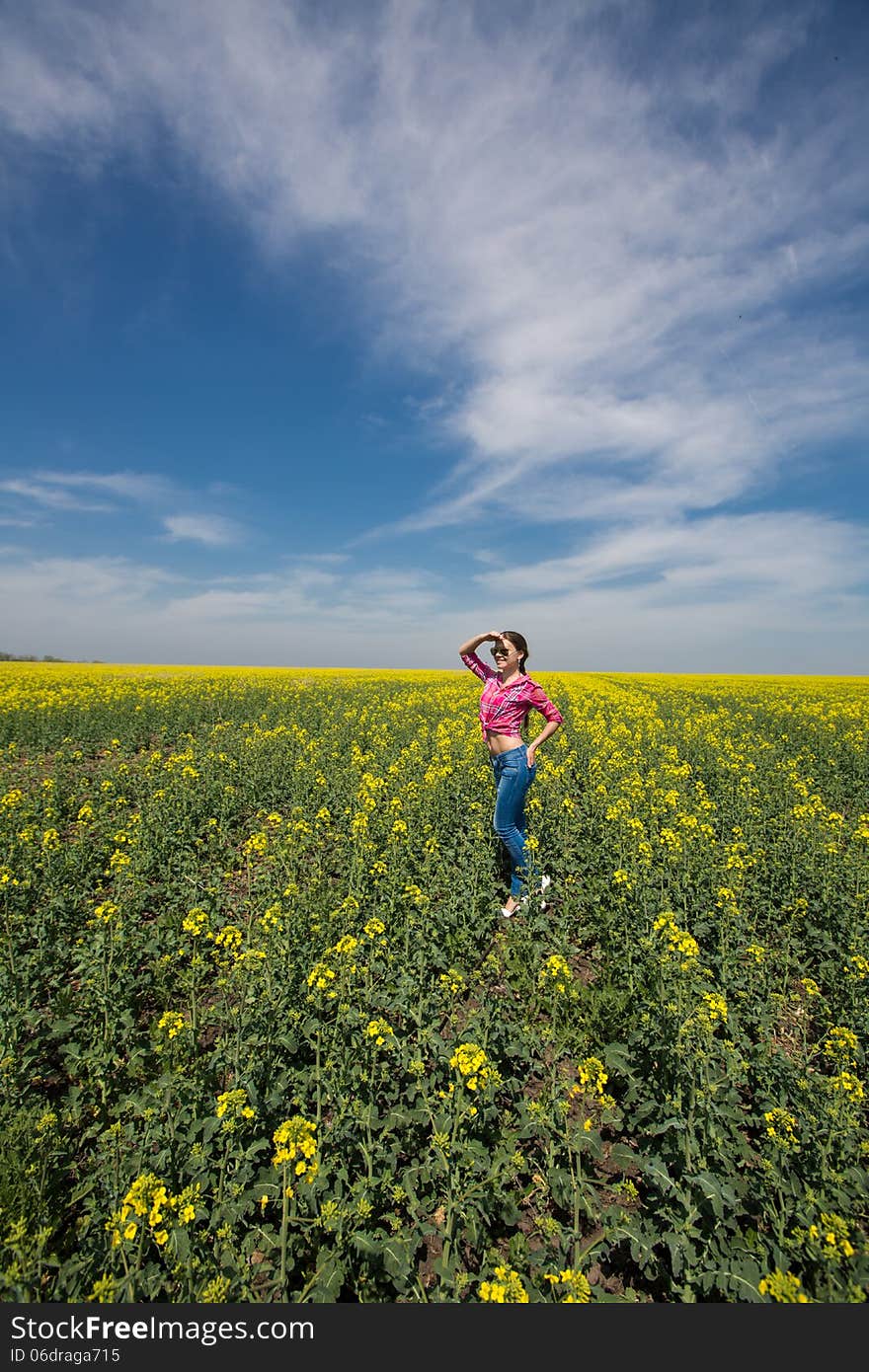 Young Beautiful Woman In Flowering Field In Summer. Outdoors