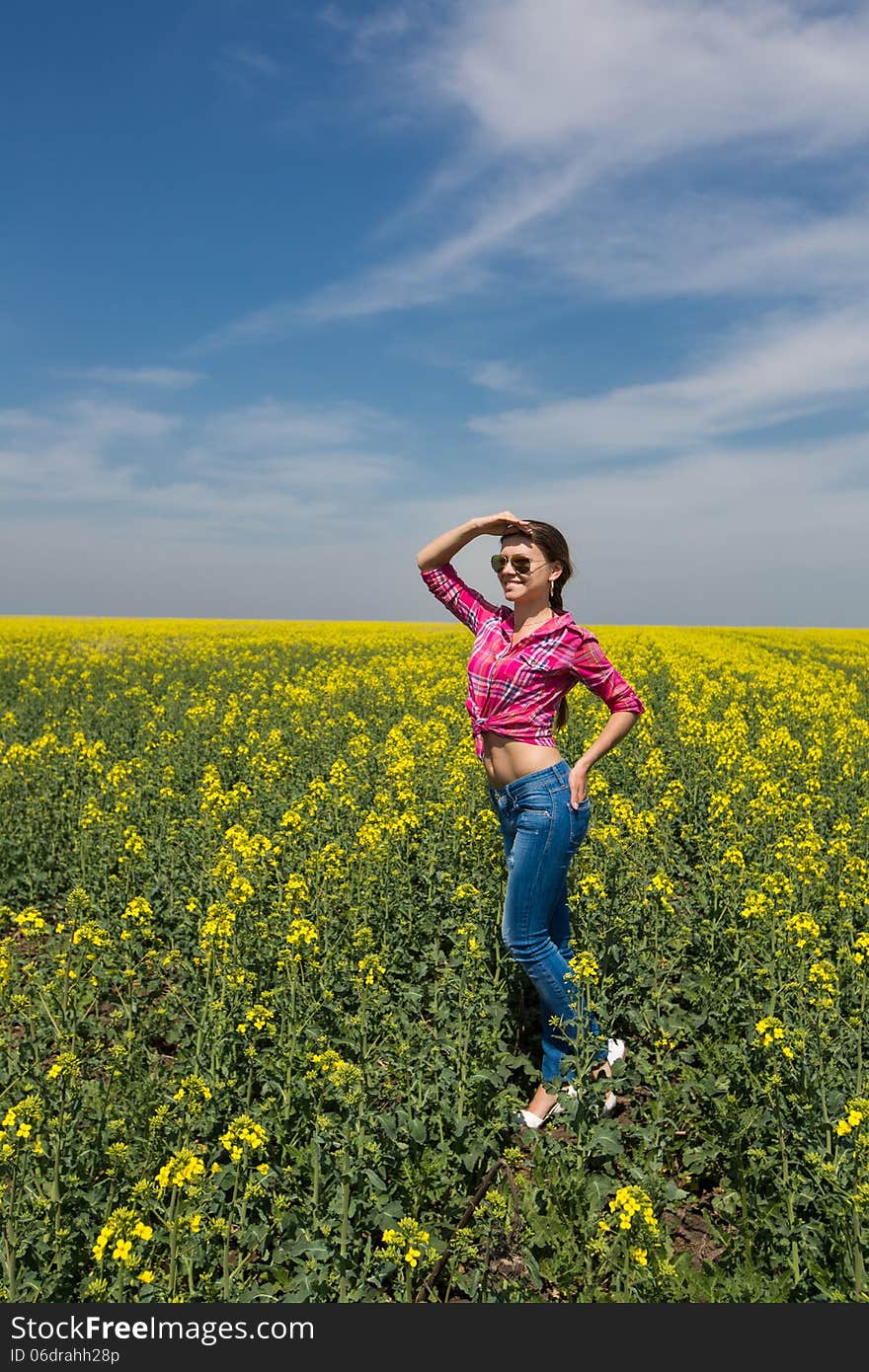 Young Beautiful Woman In Flowering Field In Summer. Outdoors