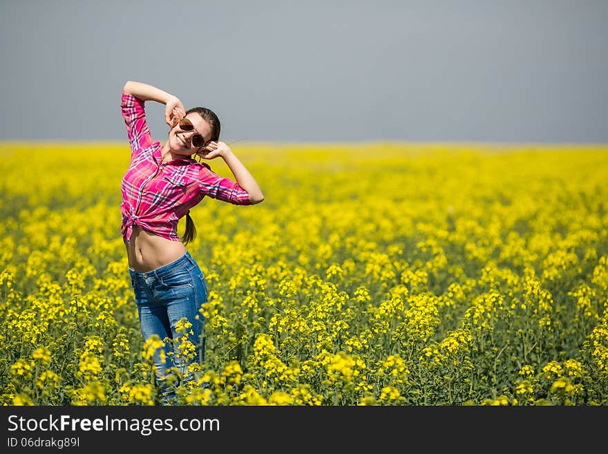 Close portrait of beautiful young woman on green grass in the summer outdoors. Close portrait of beautiful young woman on green grass in the summer outdoors