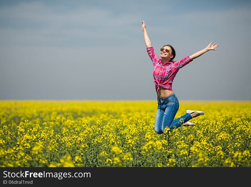 Close portrait of beautiful young woman on green grass in the summer outdoors. Close portrait of beautiful young woman on green grass in the summer outdoors