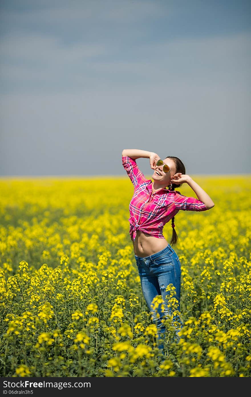 Close portrait of beautiful young woman on green grass in the summer outdoors. Close portrait of beautiful young woman on green grass in the summer outdoors