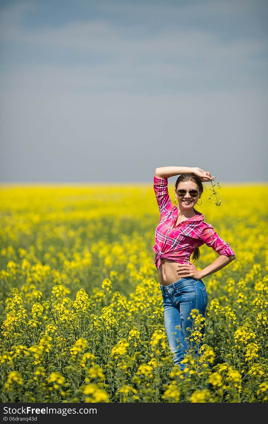 Young Beautiful Woman In Flowering Field In Summer. Outdoors