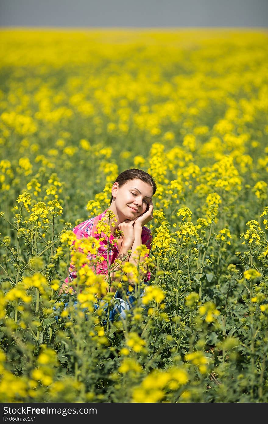 Young Beautiful Woman In Flowering Field In Summer. Outdoors