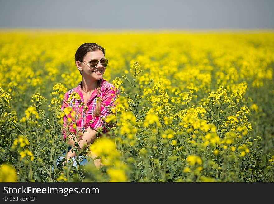 Young Beautiful Woman In Flowering Field In Summer. Outdoors