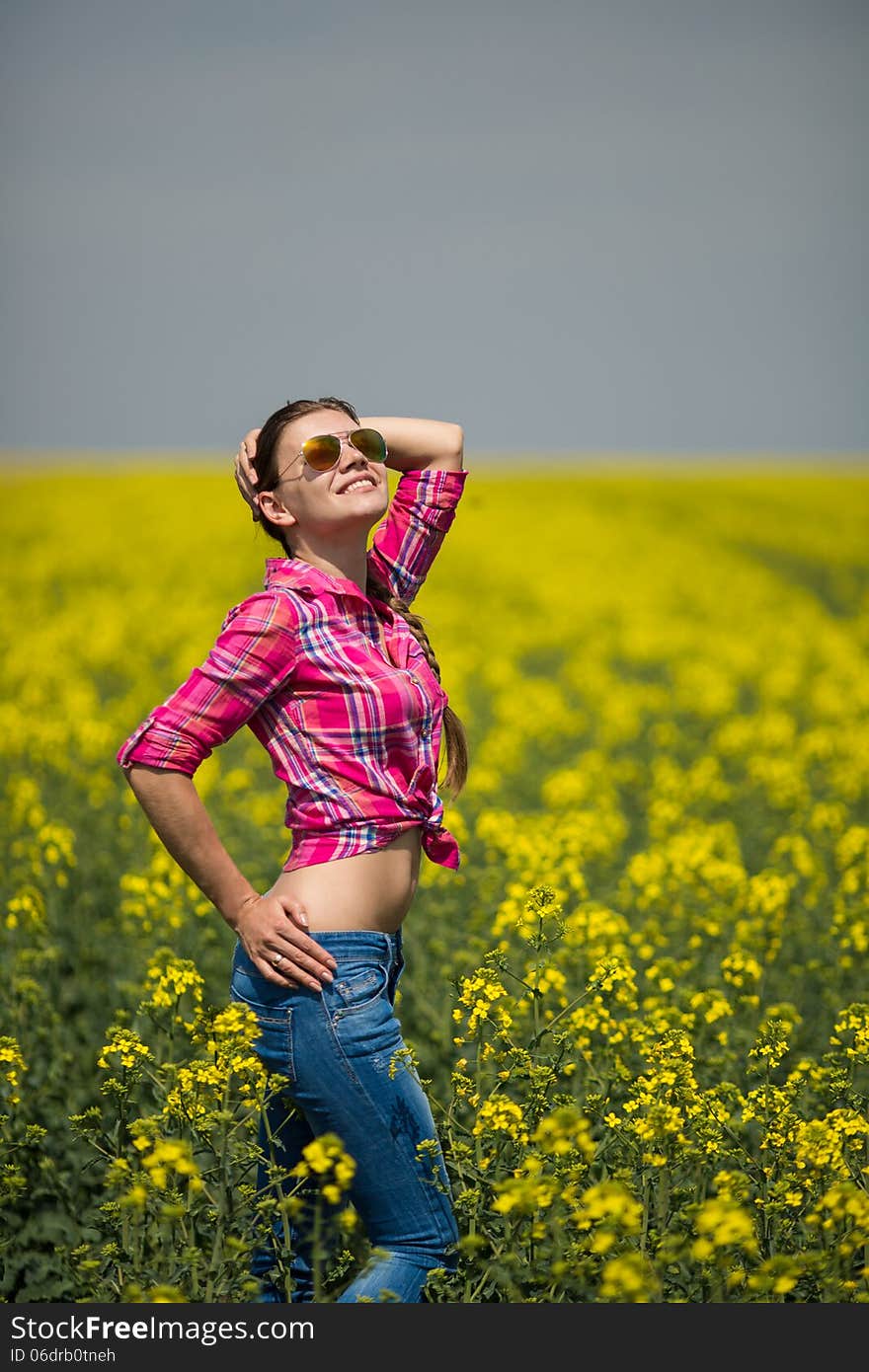 Young Beautiful Woman In Flowering Field In Summer. Outdoors