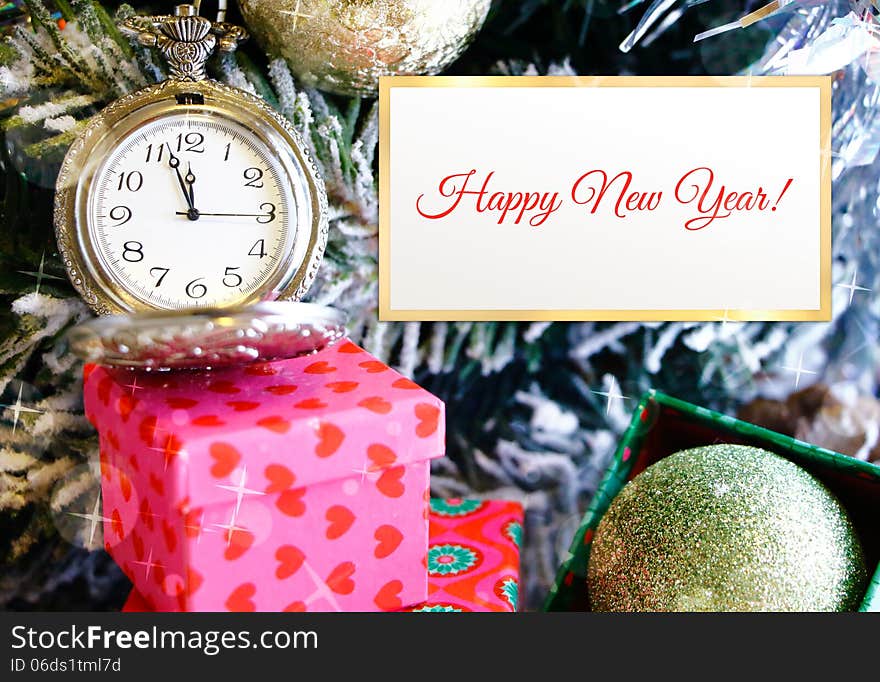 Old clock almost 12 on dial with festive tree branch and copy-space