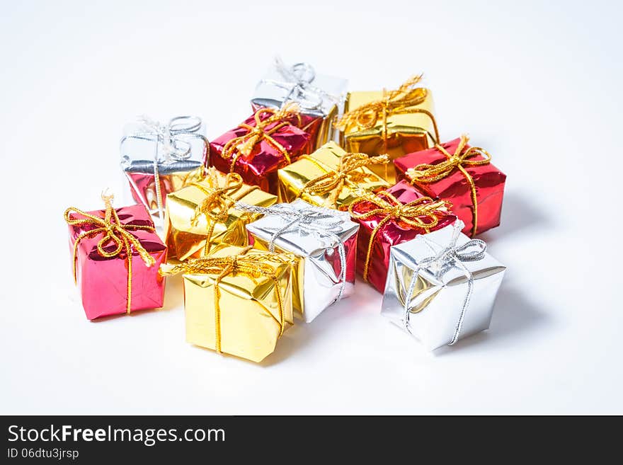 Multicolored decorative gifts on white background