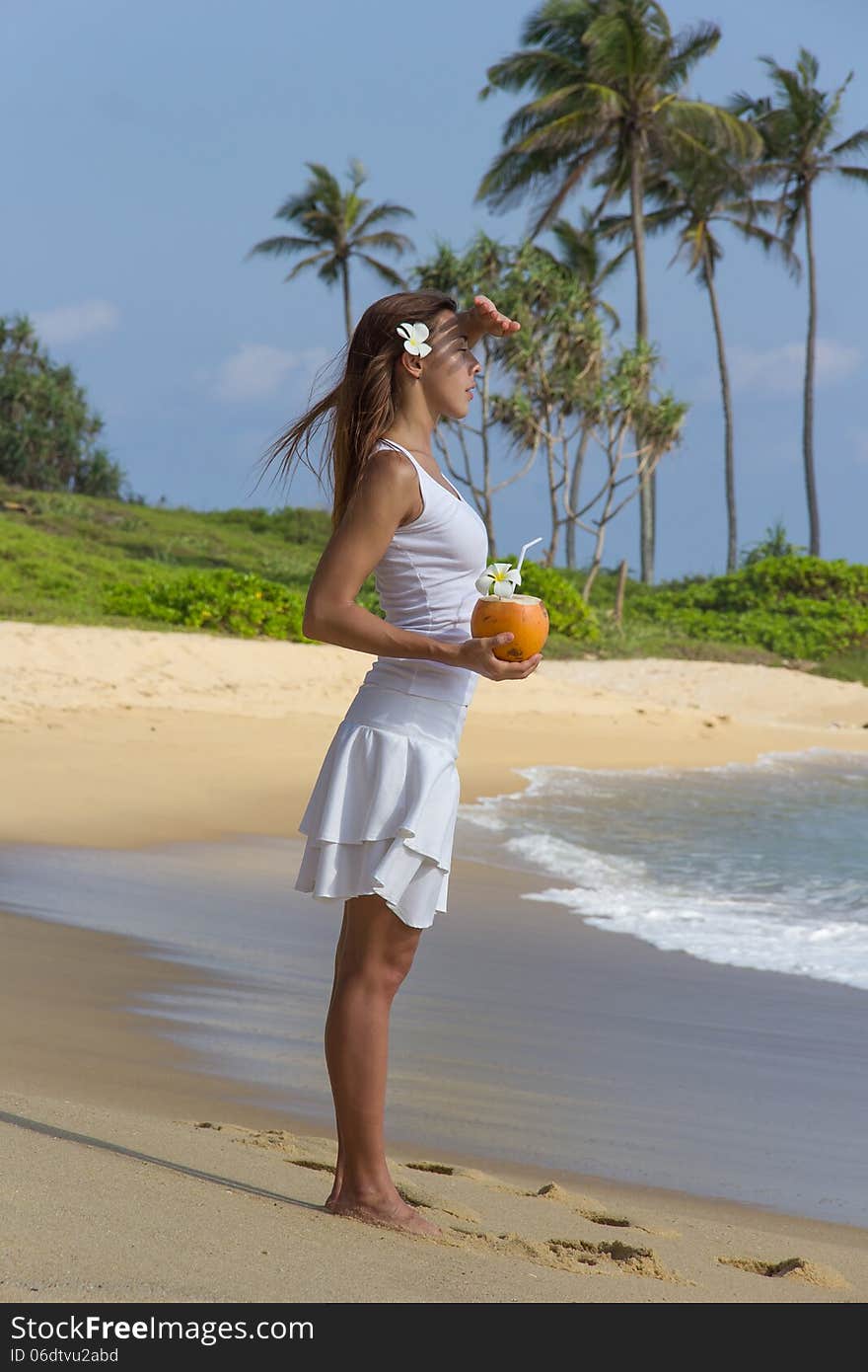 Young girl with coconut on the see side. Young girl with coconut on the see side